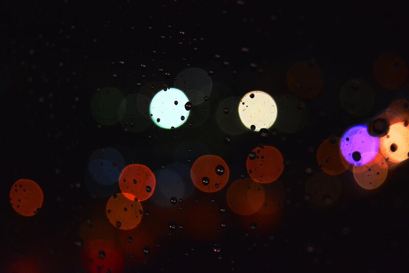 Bokeh Lights Through Raindrops — Black, Abstract