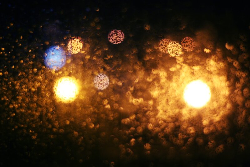 Bokeh lights through raindrops