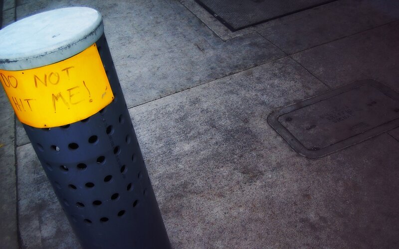 Bollard with warning sign