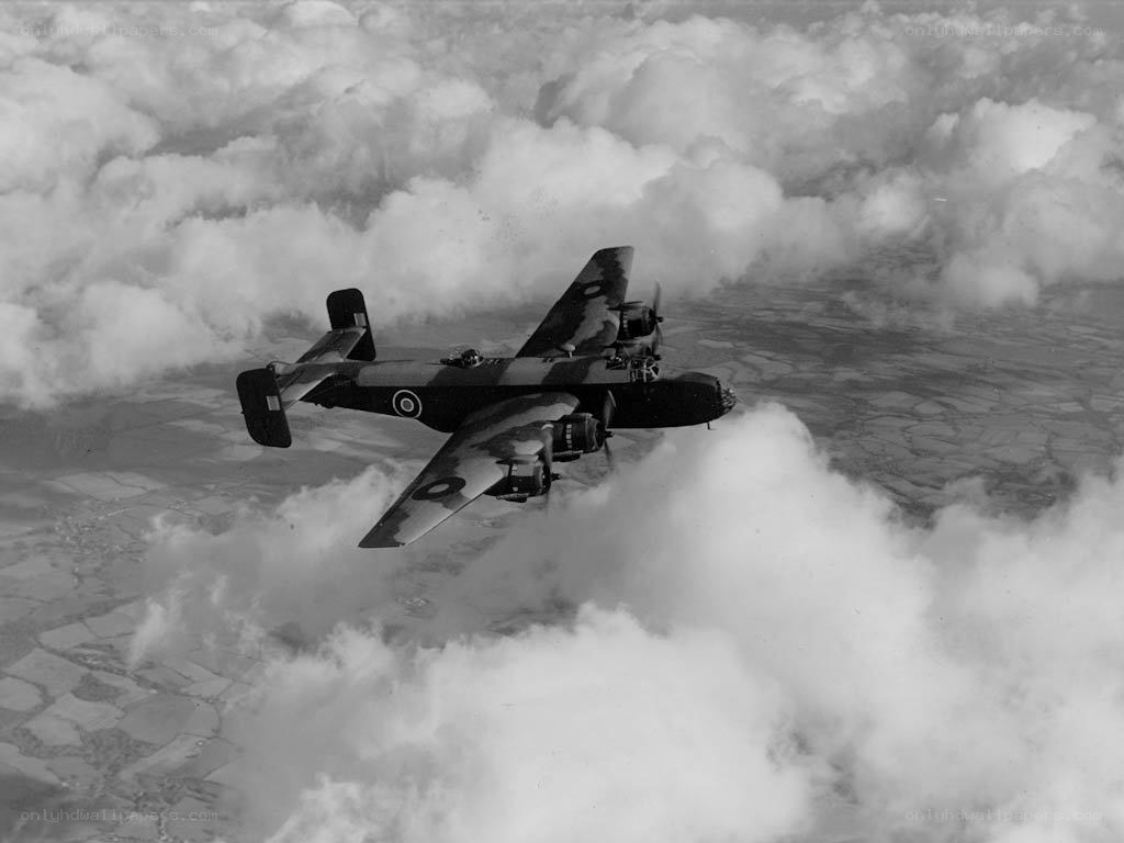 Bomber aircraft flying above clouds
