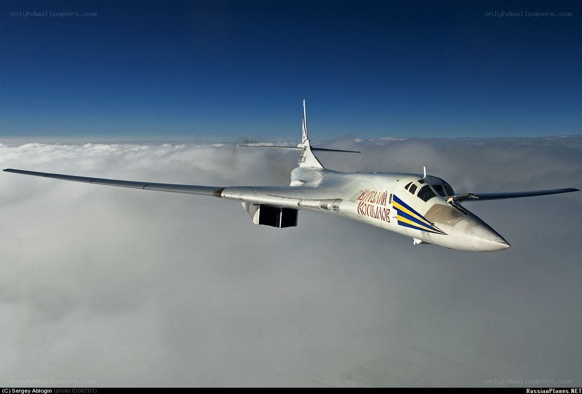 Bomber aircraft flying above clouds