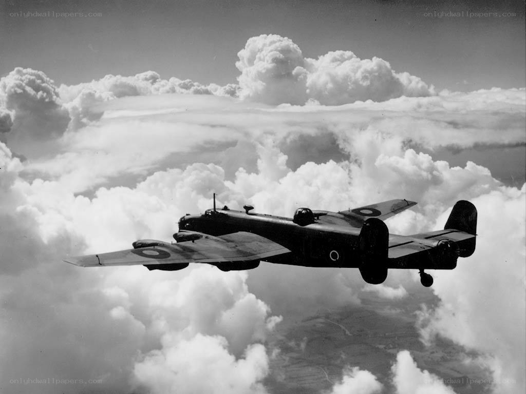 Bomber aircraft flying above clouds