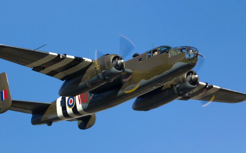 Bomber Aircraft in Flight — Blue, Dynamic, Afternoon