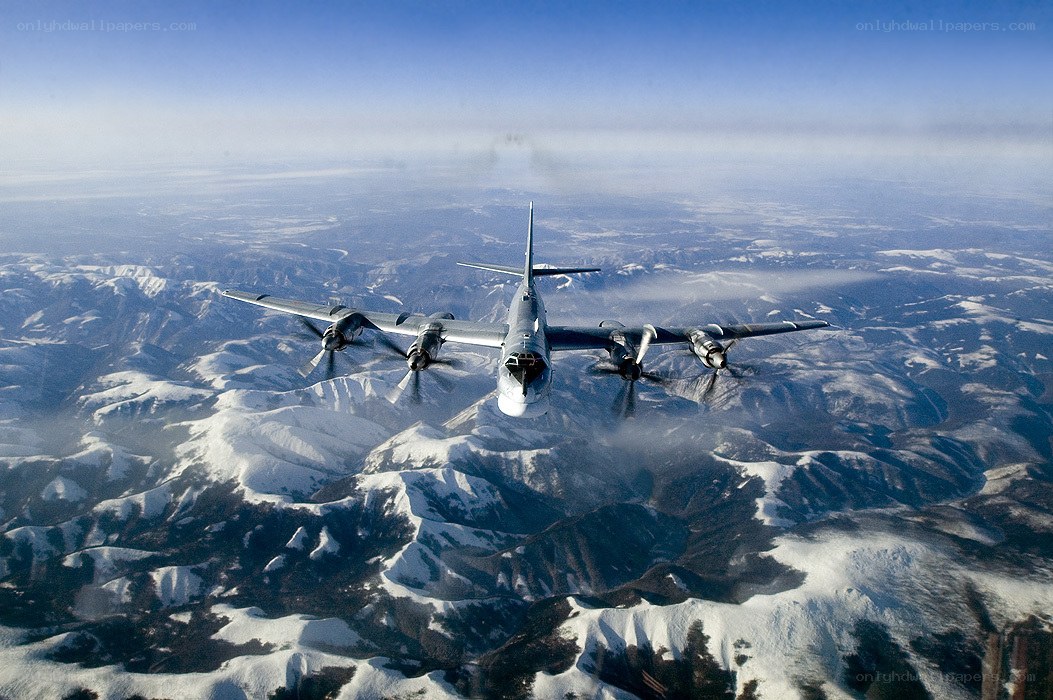 Bomber aircraft over snowy mountains