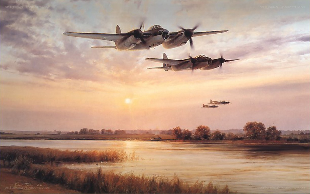 Bombers over a river at sunset