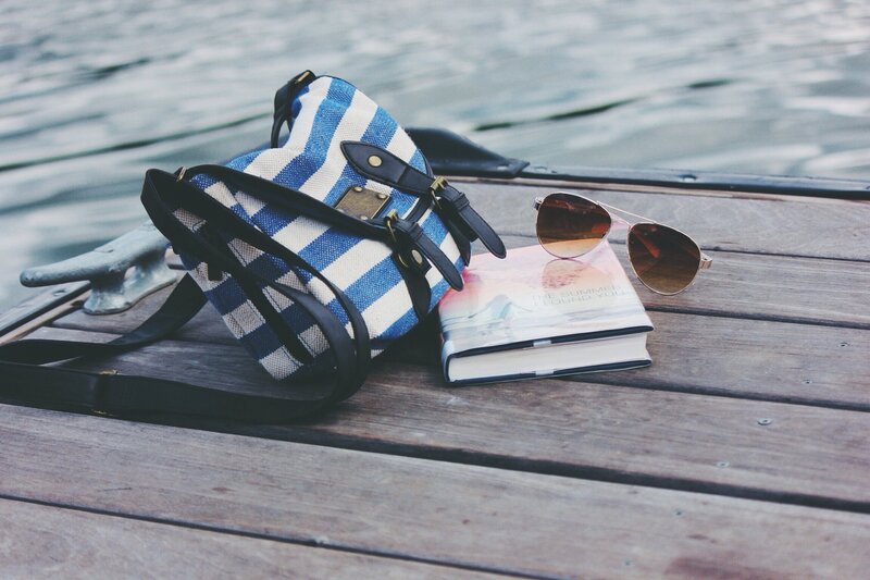Book and bag on a dock
