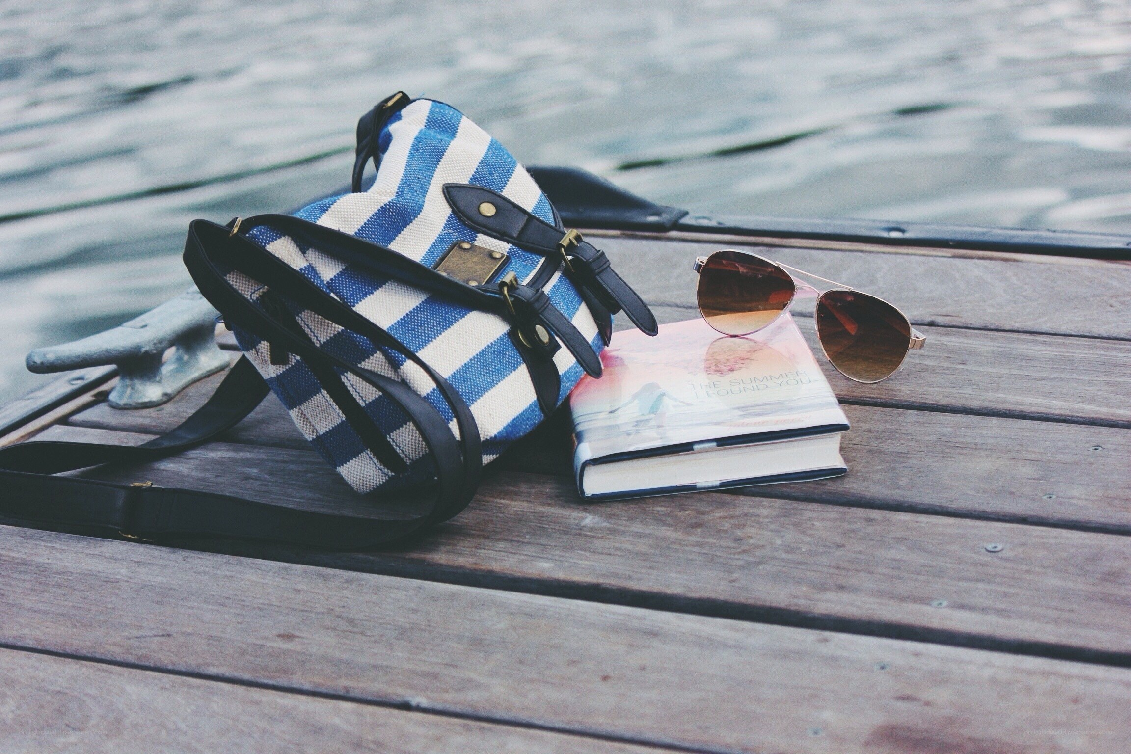Book and bag on a dock