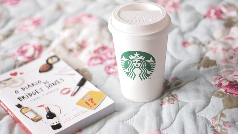 Book and coffee on floral bed