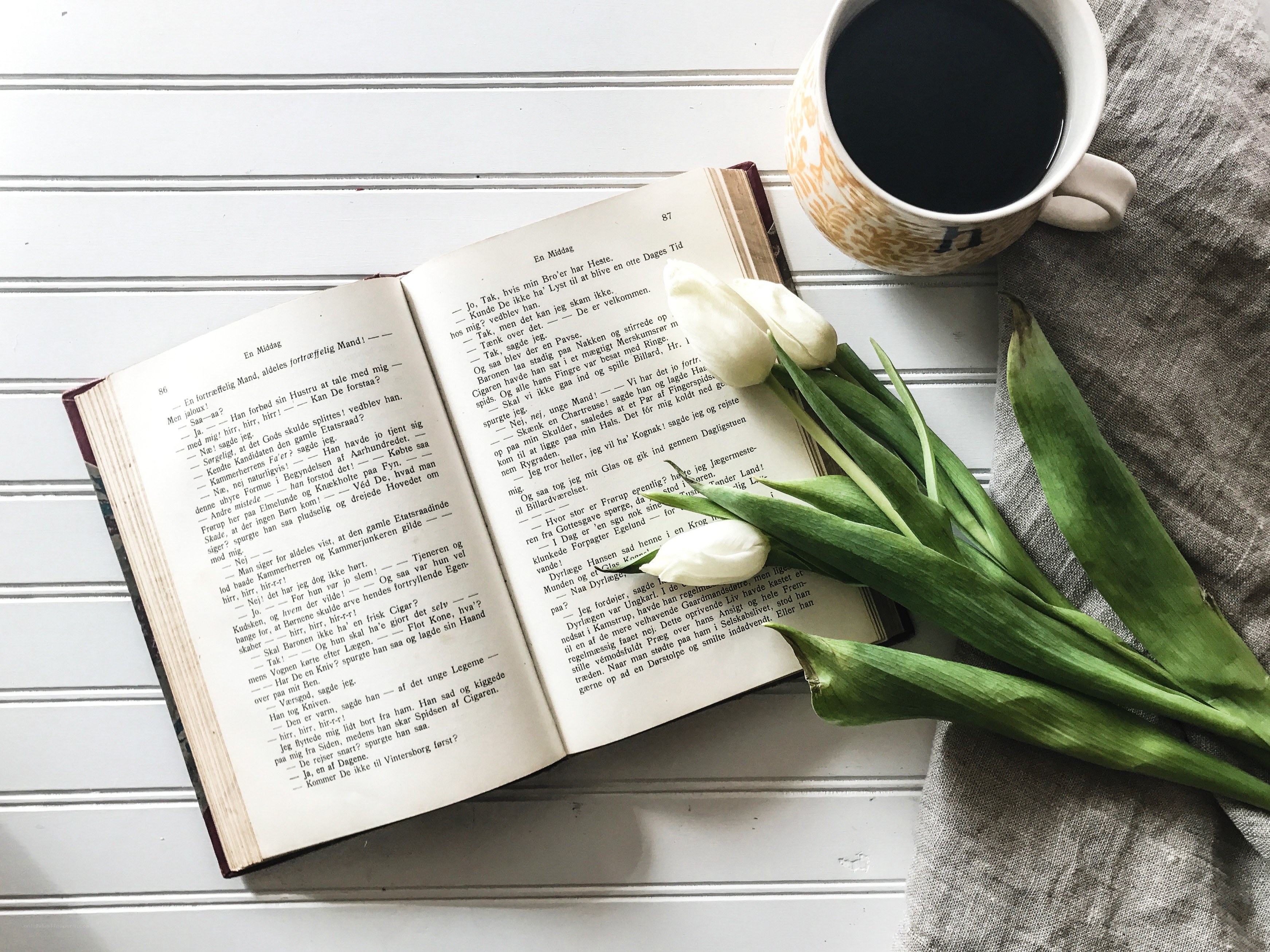 book and coffee with tulips