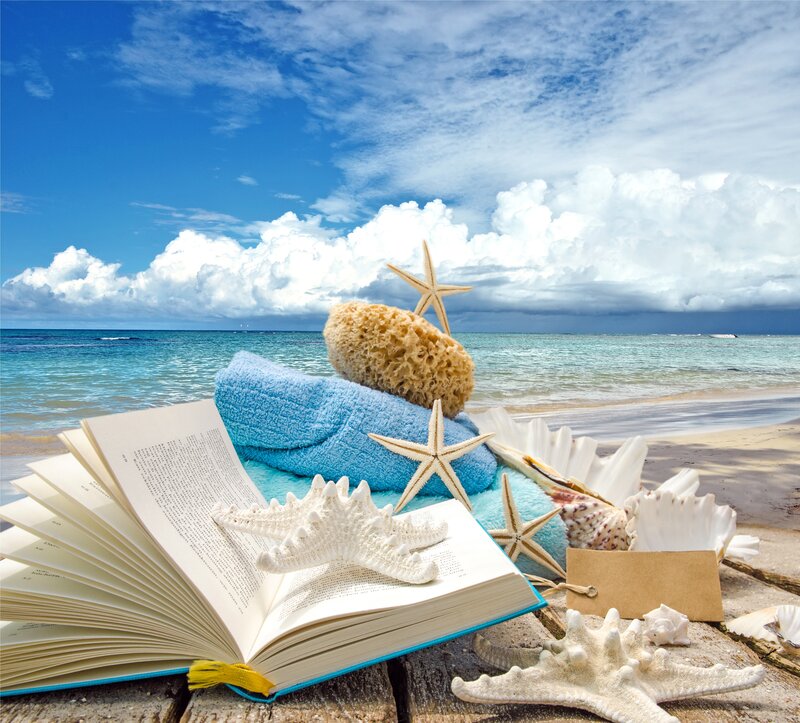Book and Seashells on Beach