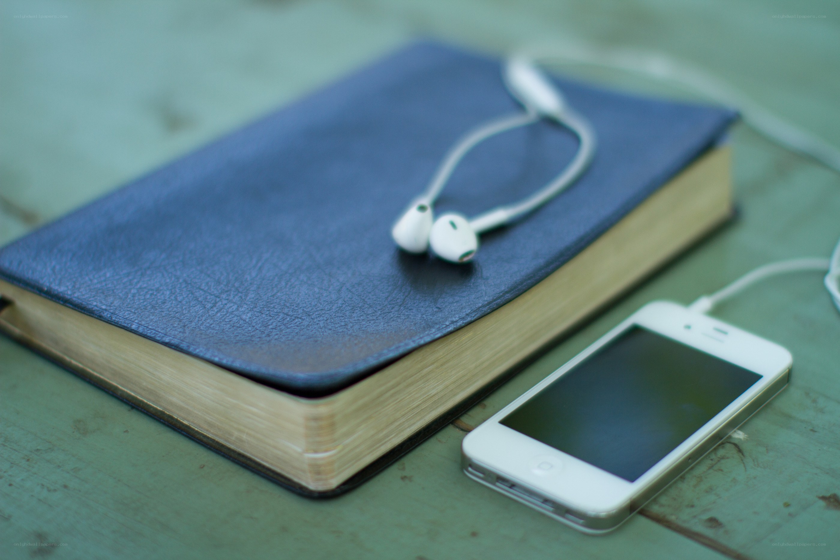 book with earbuds and phone