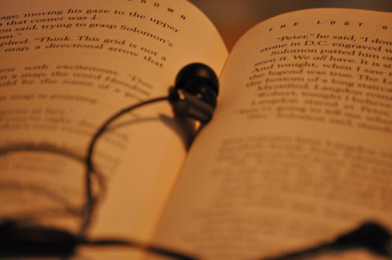 book with earbuds on pages