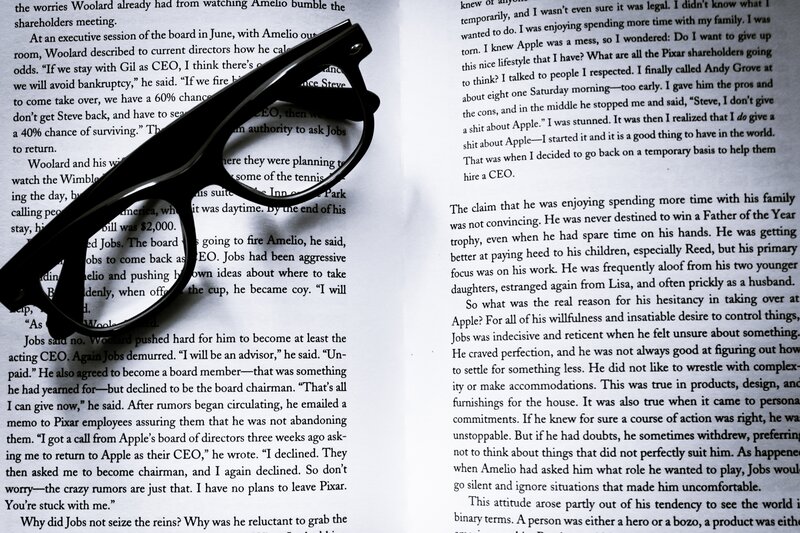 book with glasses on pages