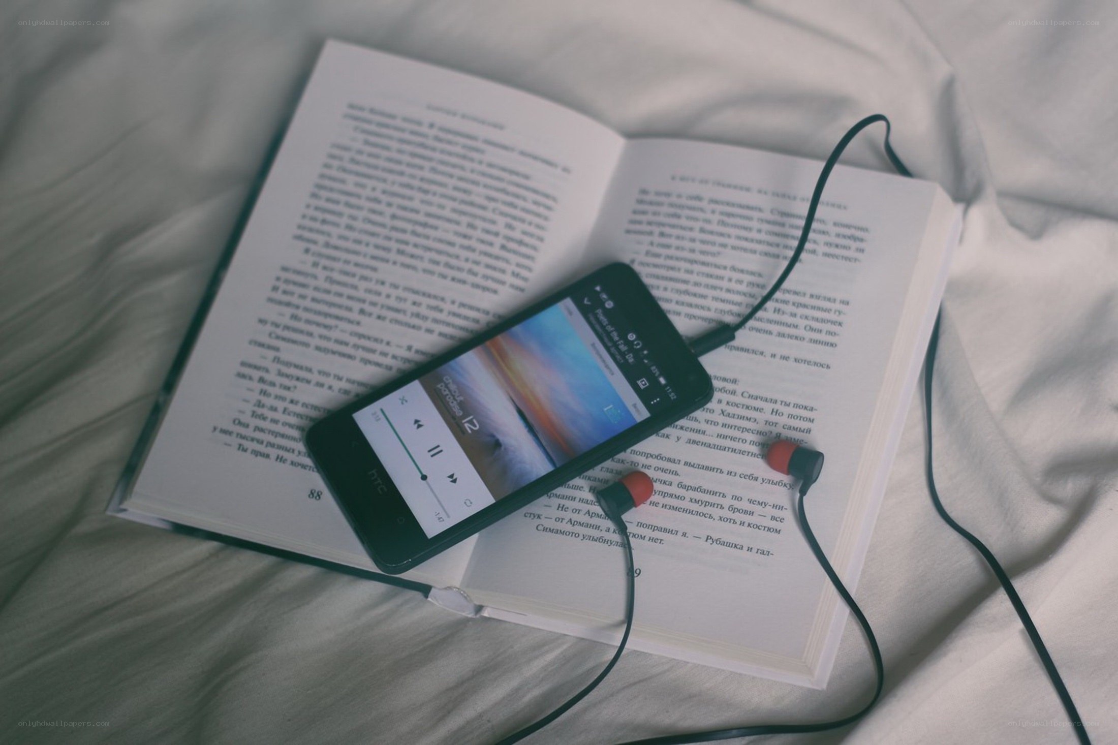 book with phone and earbuds
