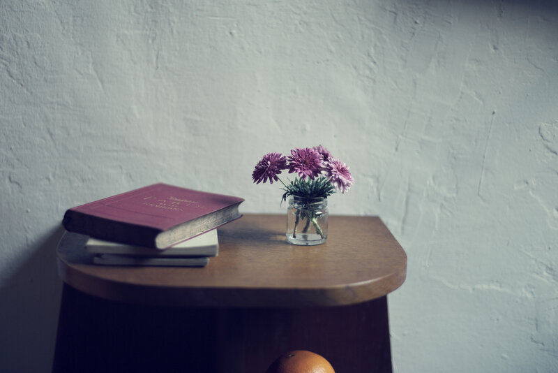 Books and Flowers on Table — Brown