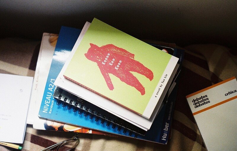 Books and notebooks on a blanket