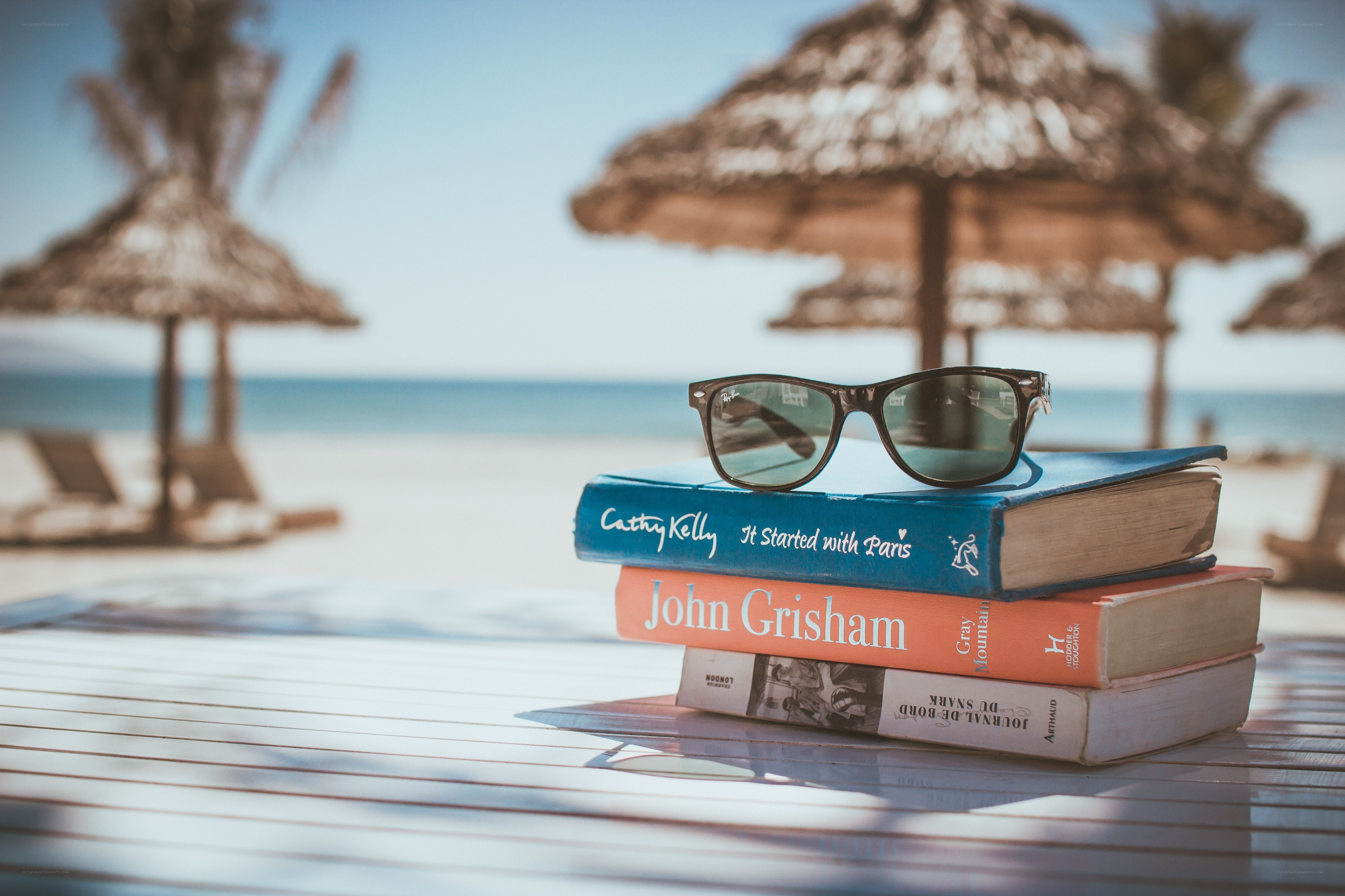 Books and sunglasses on a beach table