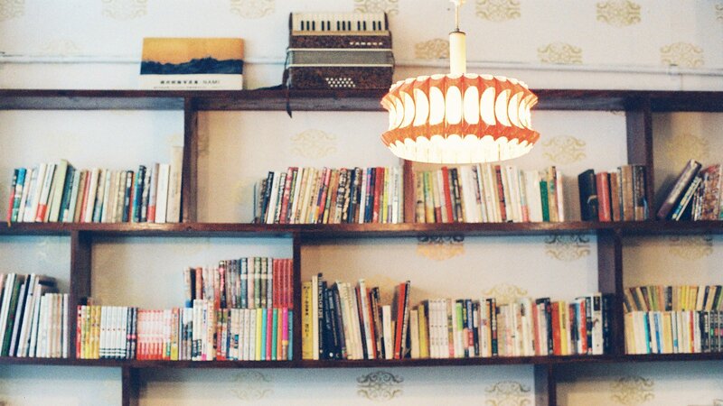 bookshelf with accordion and lamp