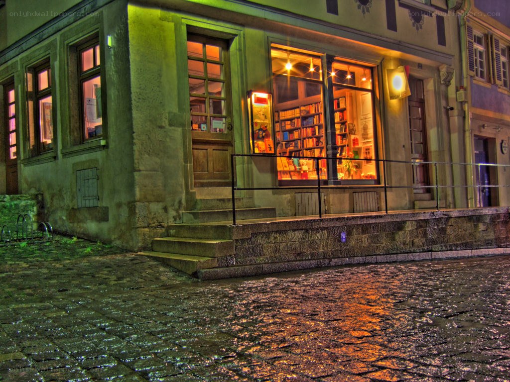 bookstore at night on cobblestone street