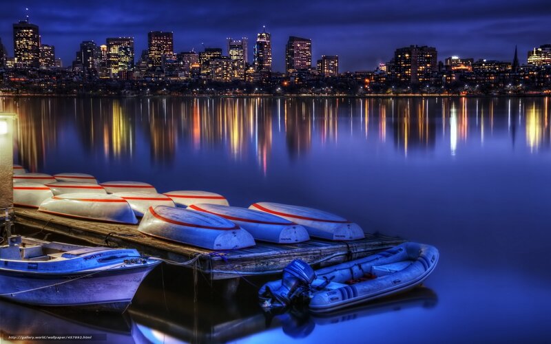 Boston skyline at night with boats