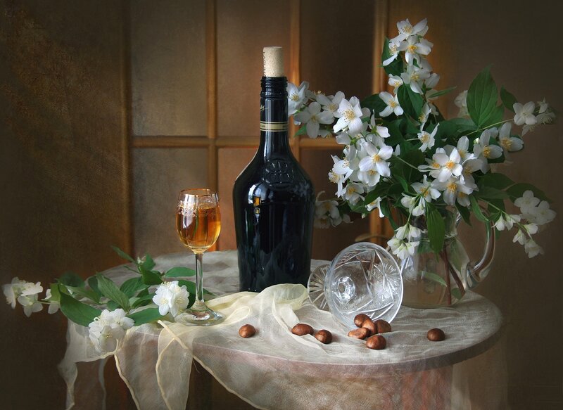 Bottle and Flowers on Table