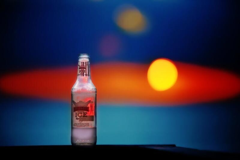 Bottle of ice drink at sunset