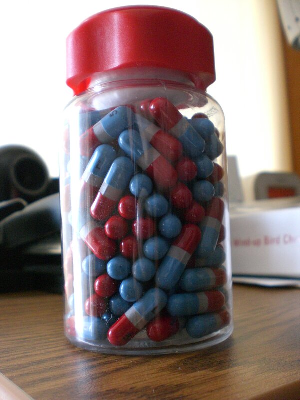 bottle of red and blue capsules