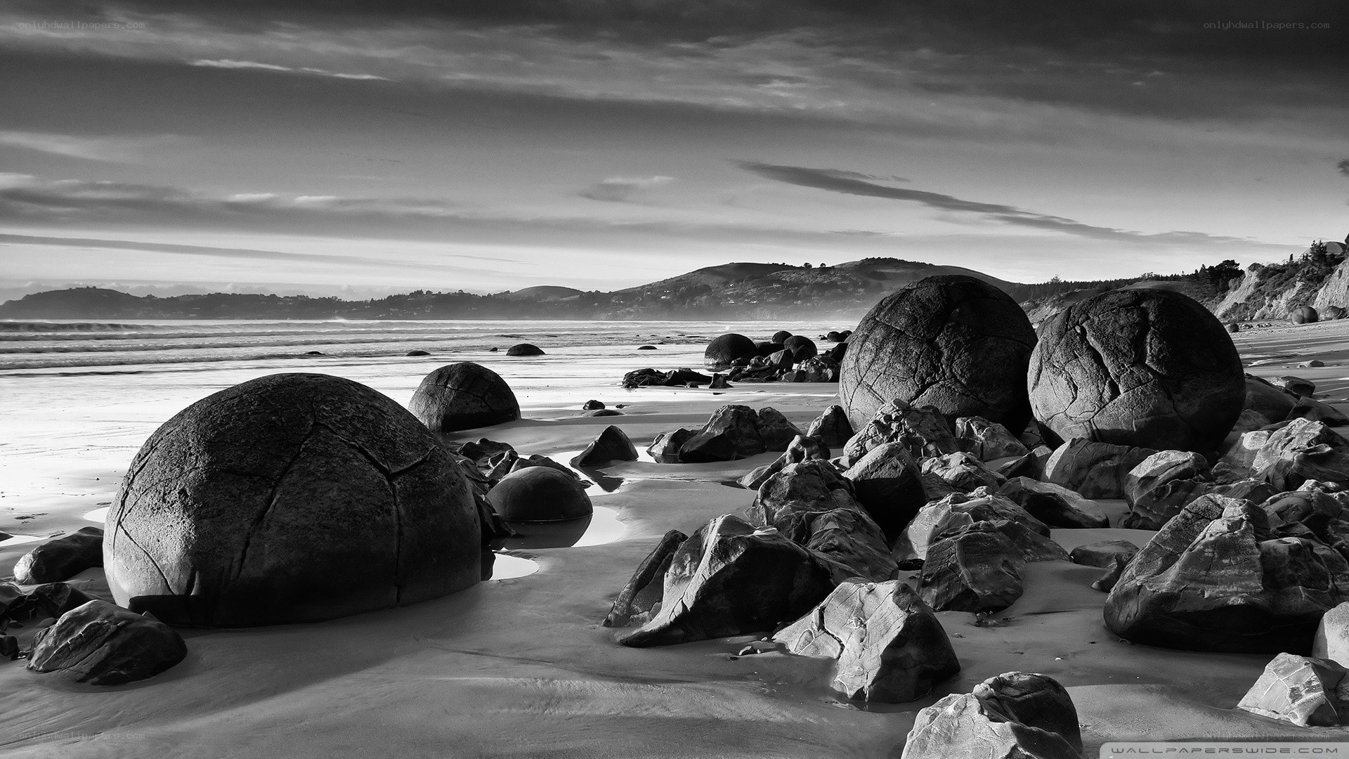 Boulders on a beach at sunset