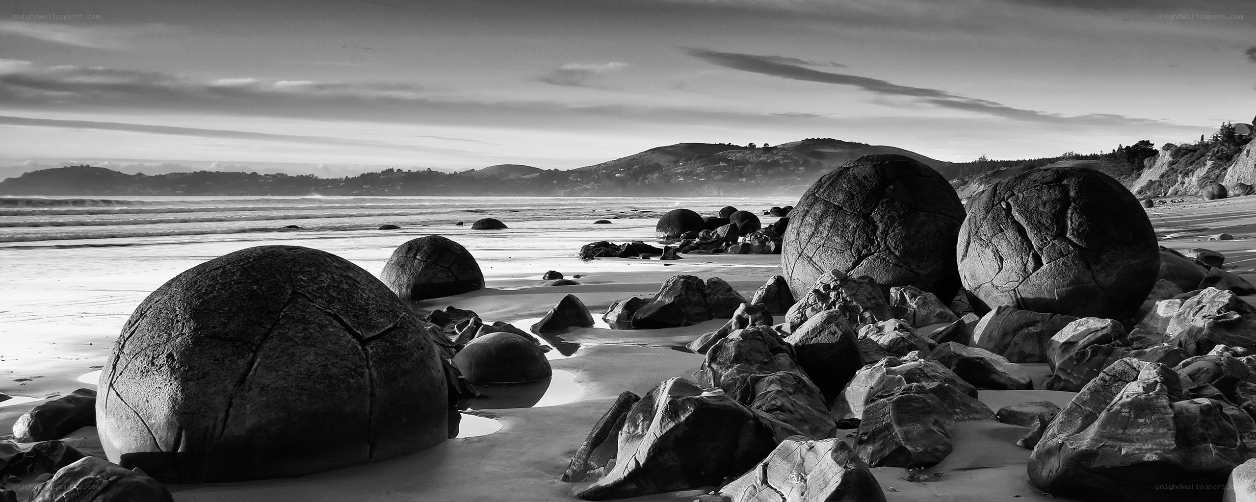 Boulders on a beach at sunset