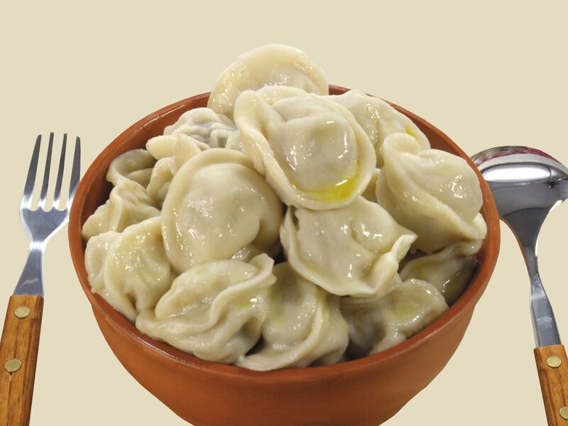 Bowl of dumplings with utensils