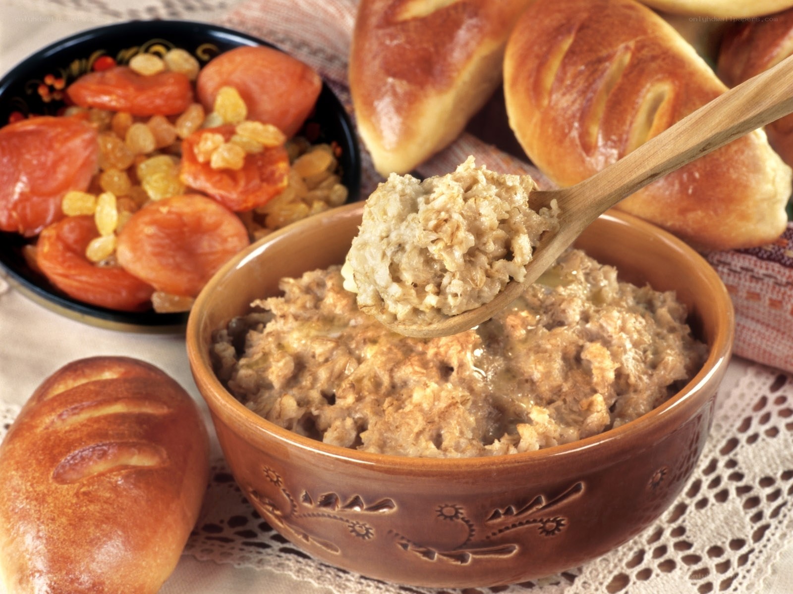 Bowl of porridge with bread and dried fruit