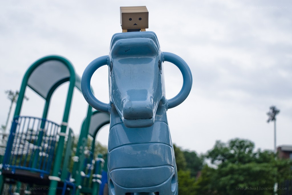 Box robot on playground horse