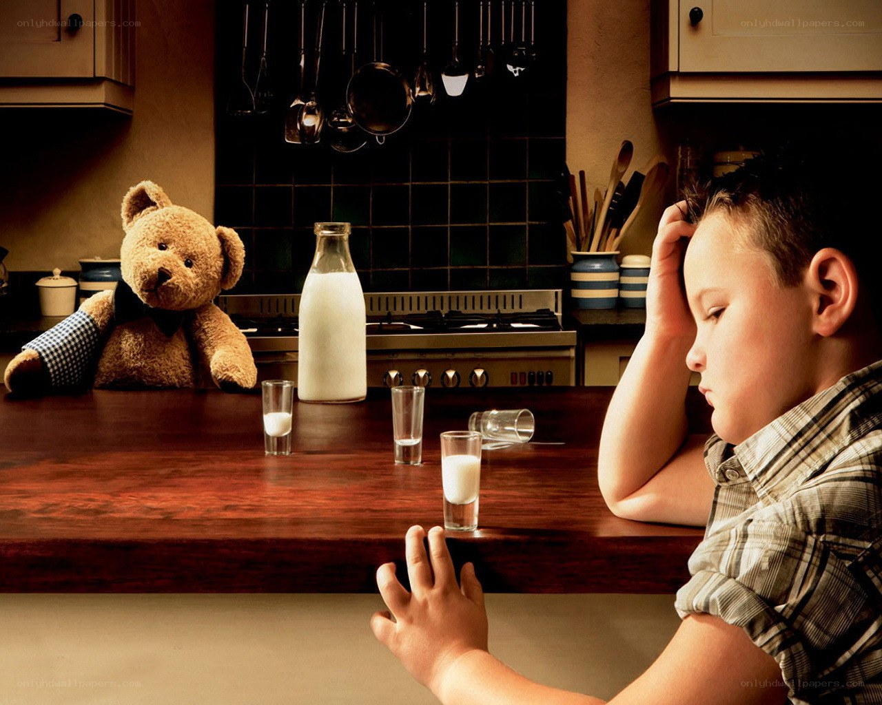 Boy and teddy bear at kitchen counter