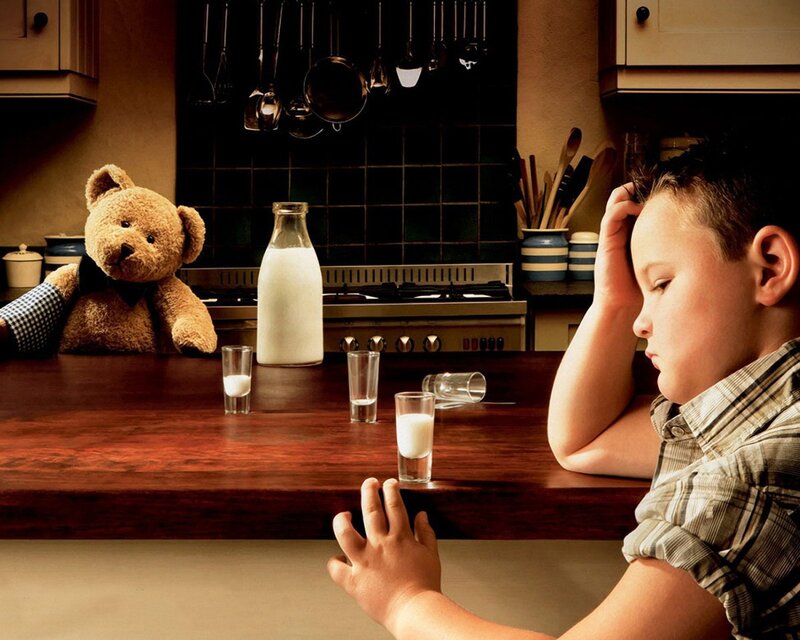 Boy and teddy bear in kitchen
