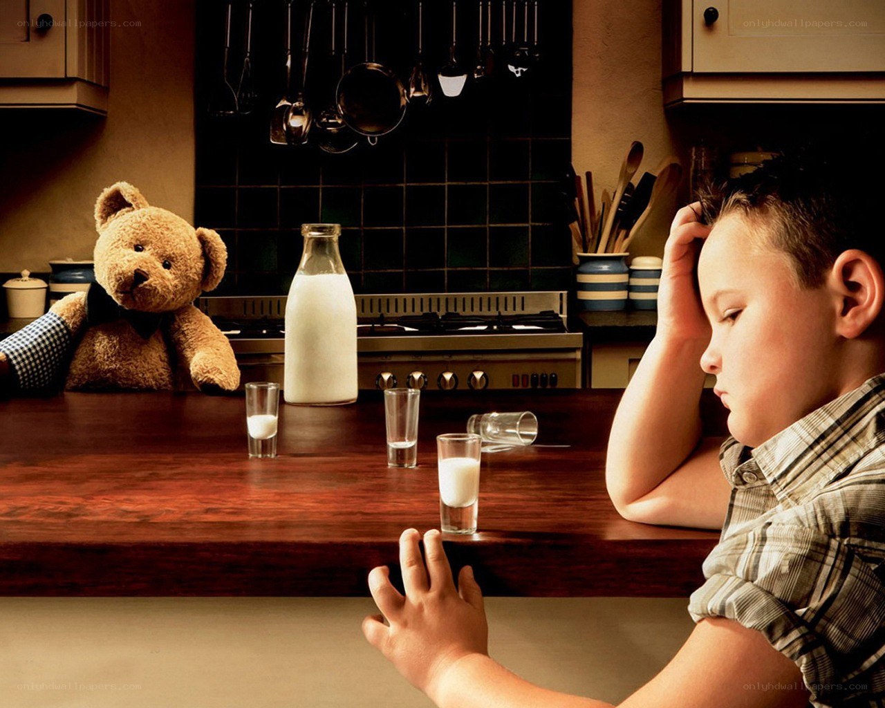 Boy and teddy bear in kitchen