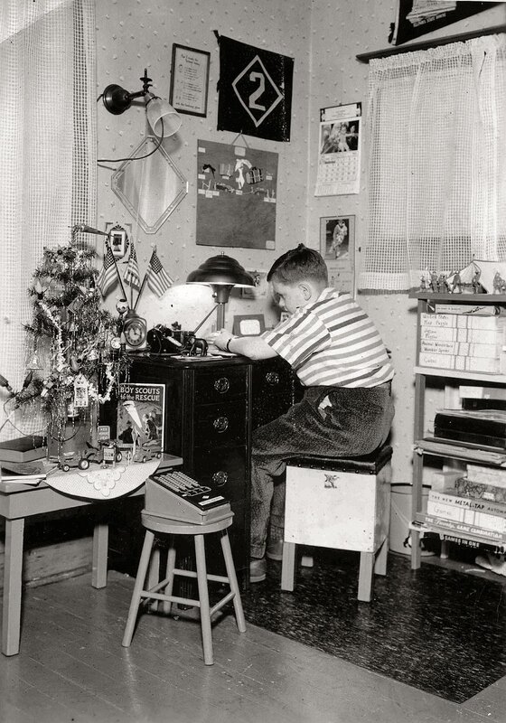 Boy at his desk with Boy Scouts items