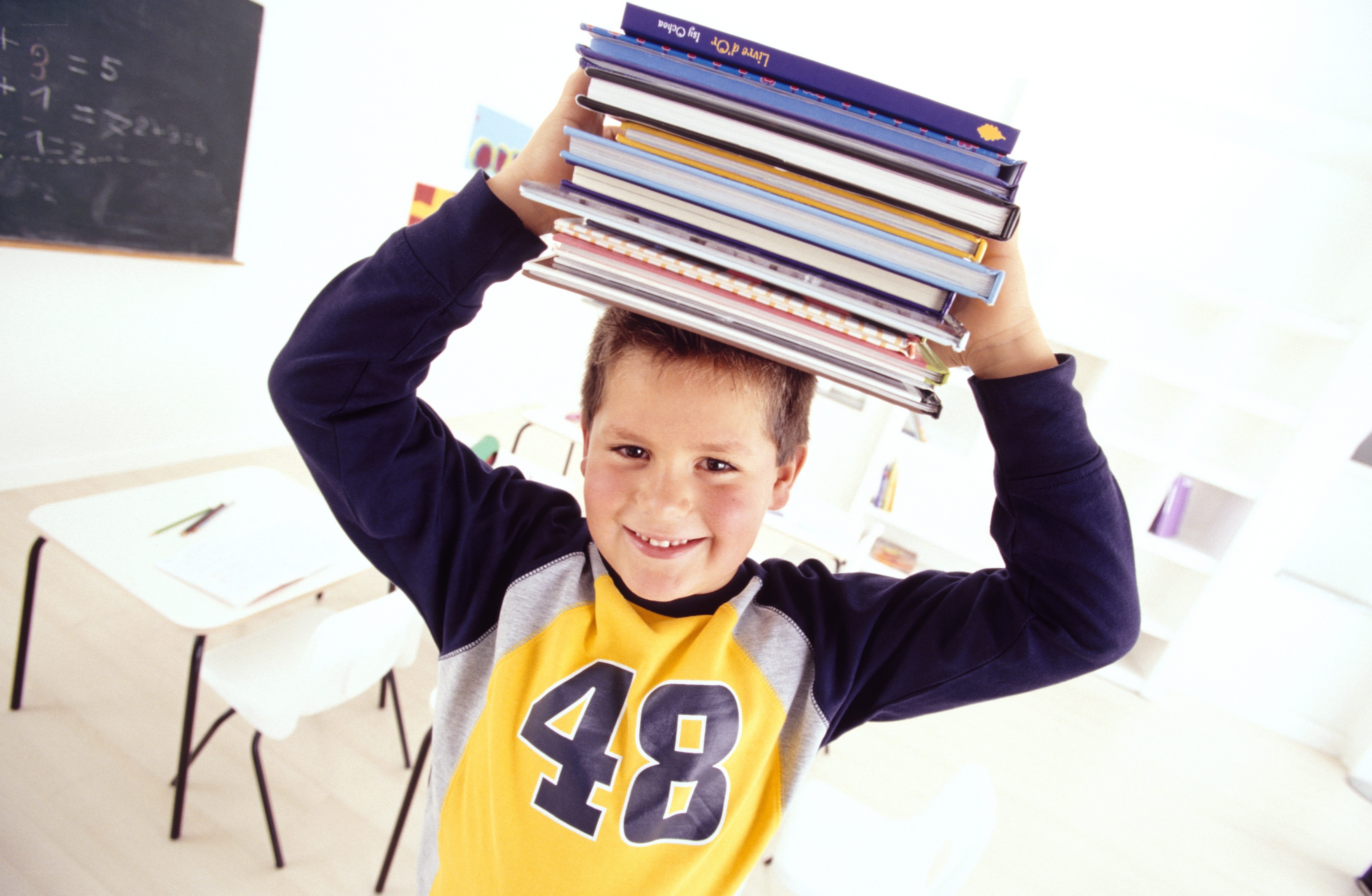 Boy balancing books on head