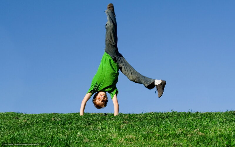 Boy doing handstand on grass