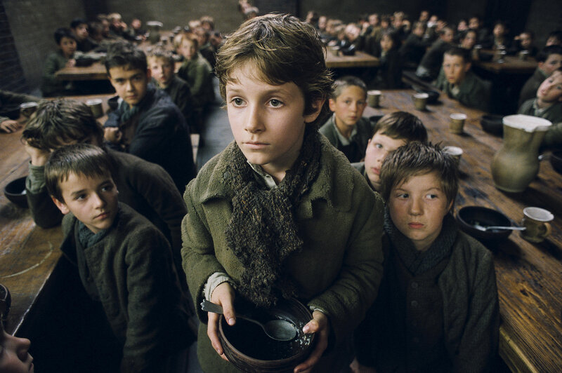 boy holding bowl in dining hall