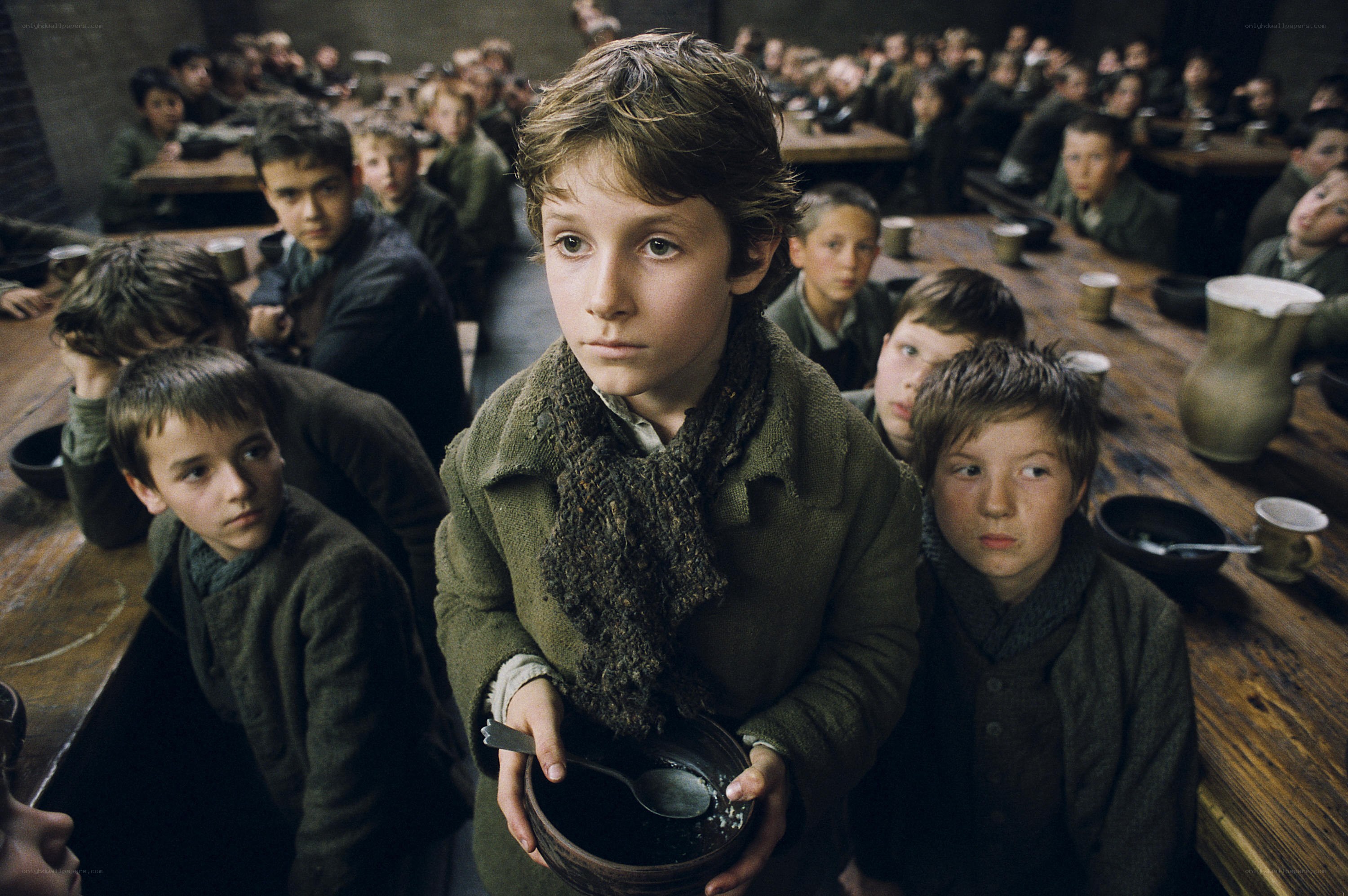 boy holding bowl in dining hall