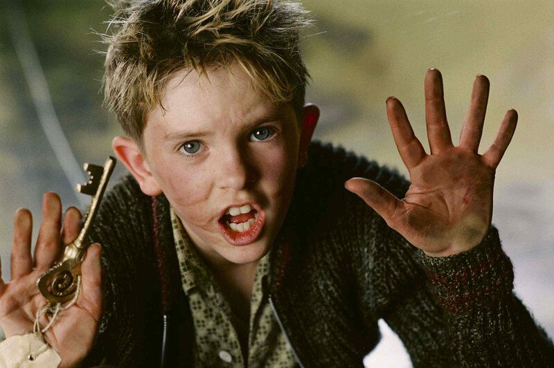 boy holding golden key