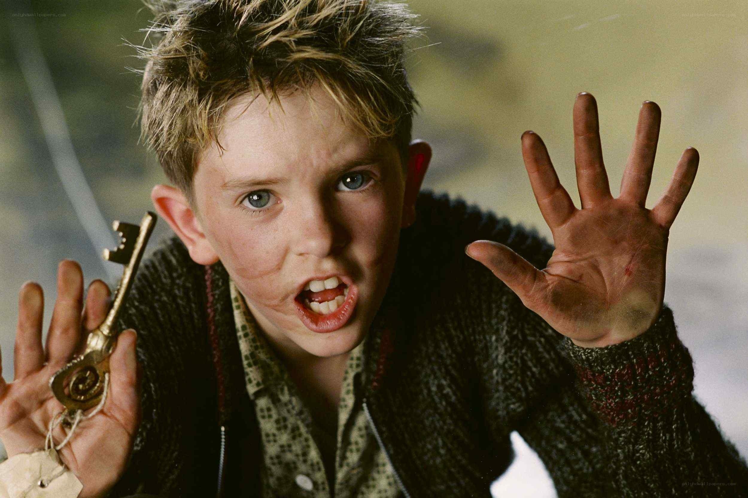 boy holding golden key