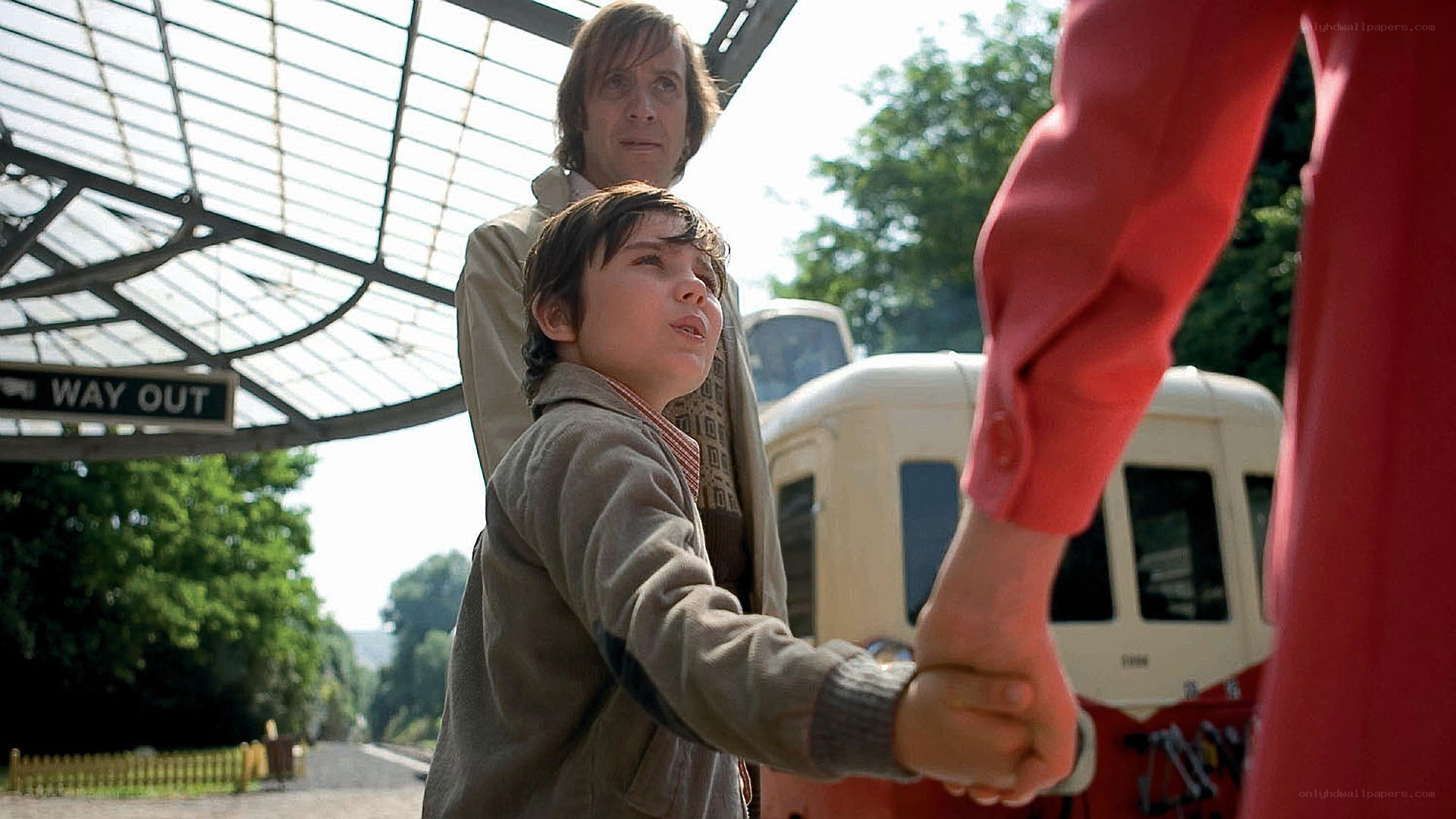 boy holding hand at train station