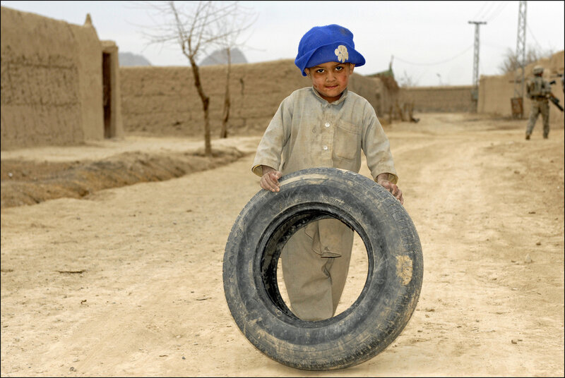 Boy Holding Tire