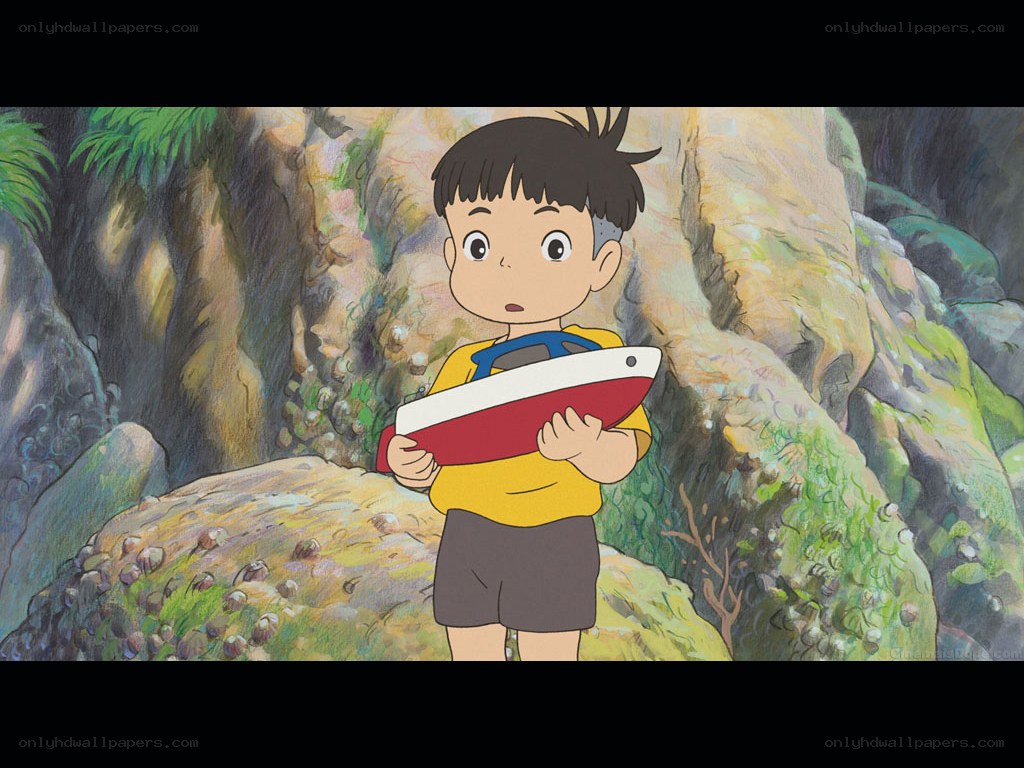 boy holding toy boat