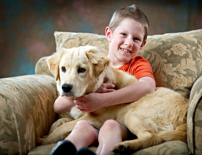 Boy Hugging Golden Retriever