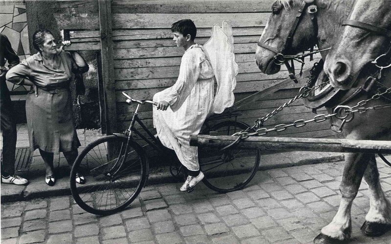 Boy in angel costume with bicycle