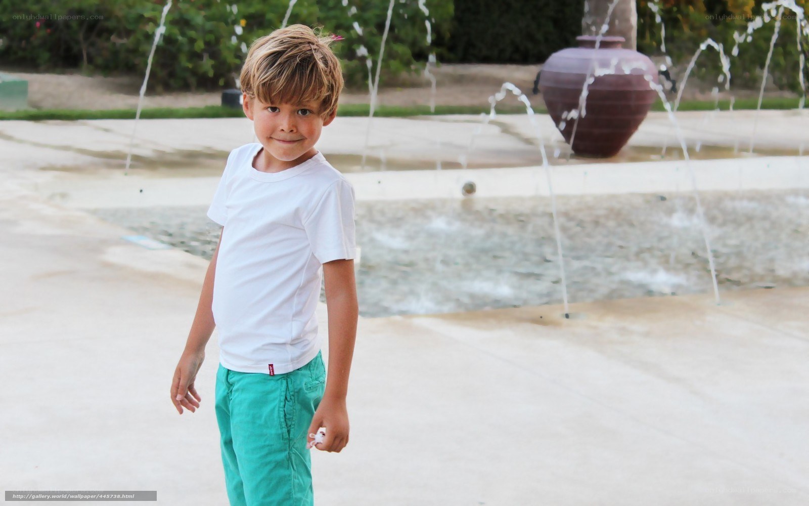 Boy in front of fountain