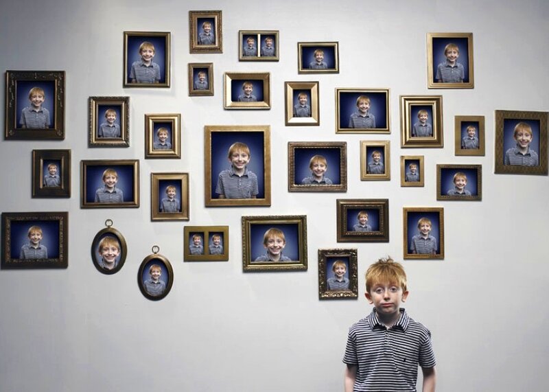 Boy in front of photo wall