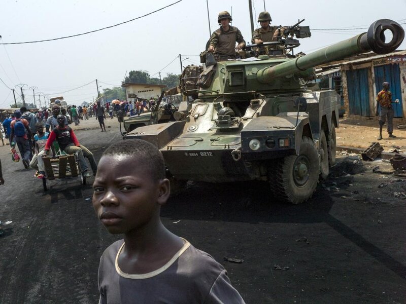 Boy in Front of Tank